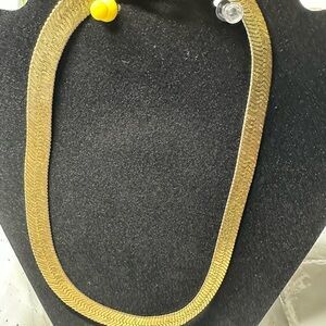 This is a gold-tone herringbone chain necklace